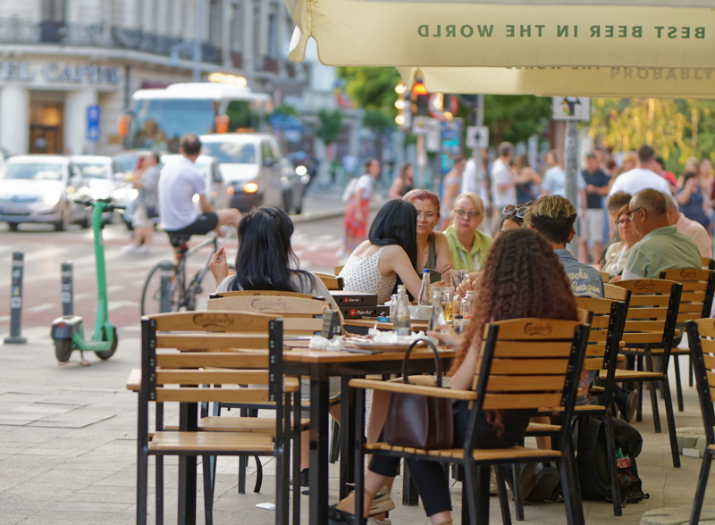 26 - Crowded outdoor terrace scene capturing a lively dining atmosphere in the center of Bucharest
